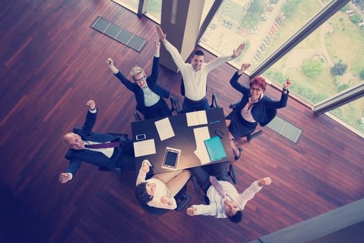 happy business people group on meeting at modern office photo