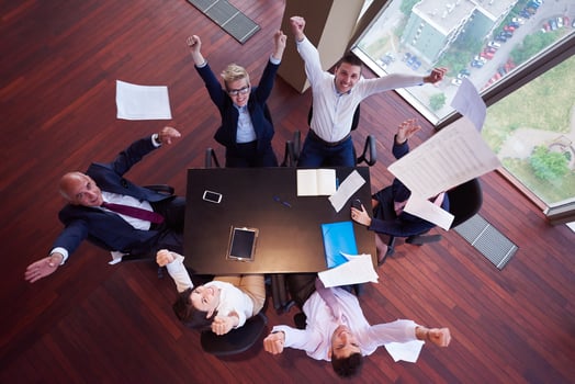 top view of business people group throwing dociments in air photo