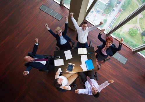 top view of business people group throwing dociments in air photo