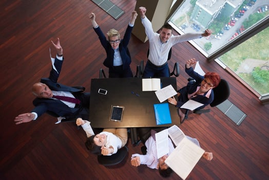 top view of business people group throwing dociments in air photo