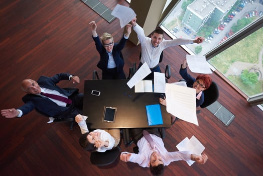 top view of business people group throwing dociments in air photo