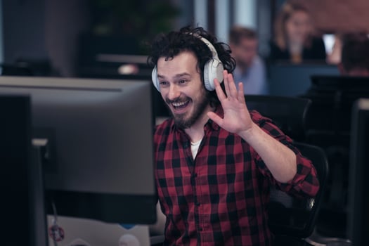 Funny businessman wearing headset having virtual team meeting group call chatting with diverse people in customer support. Video conference call on computer with manager and employees. photo
