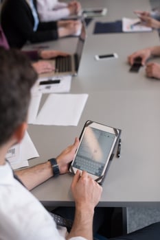 close up of  businessman hands  using tablet on meeting photo
