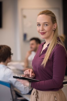 blonde businesswoman working on tablet at office photo