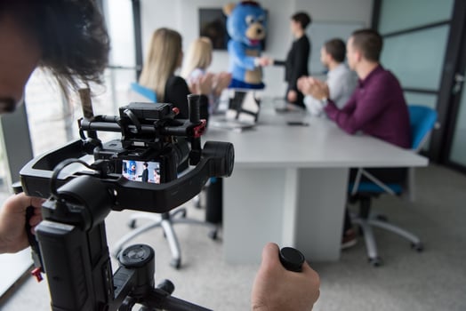 boss dresed as bear having fun with business people in trendy office photo