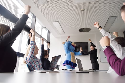 boss dresed as bear having fun with business people in trendy office photo