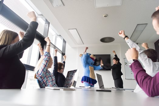 boss dresed as bear having fun with business people in trendy office photo