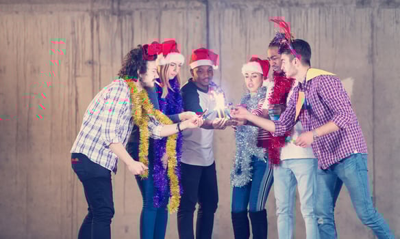 multiethnic group of casual business people lighting a sparkler photo