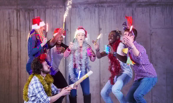 multiethnic group of casual business people dancing with sparklers photo