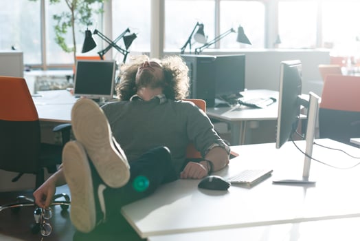 businessman sitting with legs on desk photo