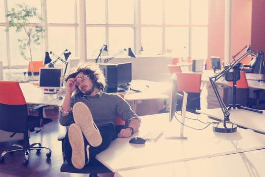 businessman sitting with legs on desk photo