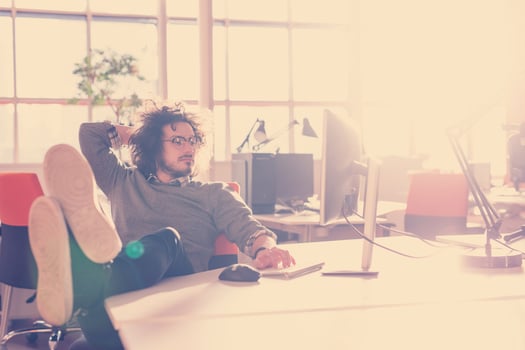 businessman sitting with legs on desk photo