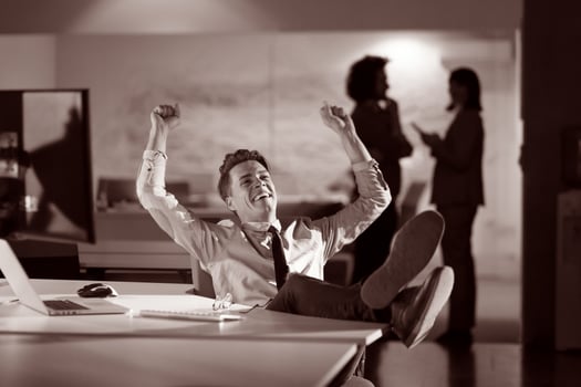businessman sitting with legs on desk at office photo