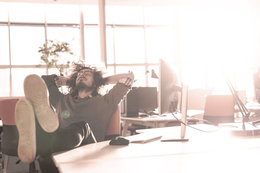businessman sitting with legs on desk photo