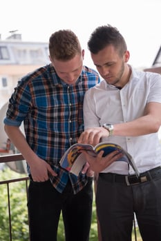 young men standing at balcony photo