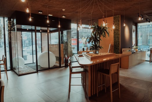 Modern interior of coffee shop with selective focusing on wooden top table in morning light for montage product display photo