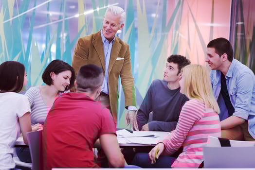 teacher with a group of students in classroom photo