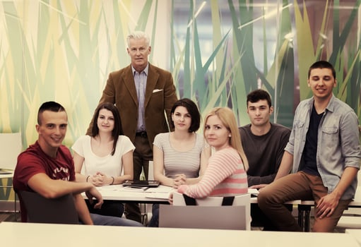 portrait of  teacher with students group in background photo