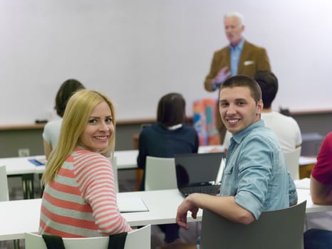 teacher with a group of students in classroom photo