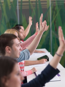 students group raise hands up on class photo