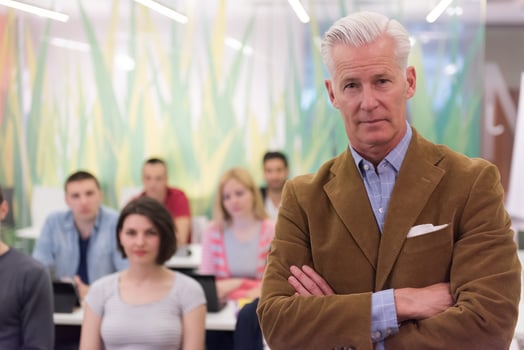 portrait of  teacher with students group in background photo