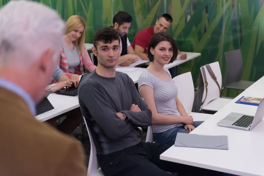teacher with a group of students in classroom photo