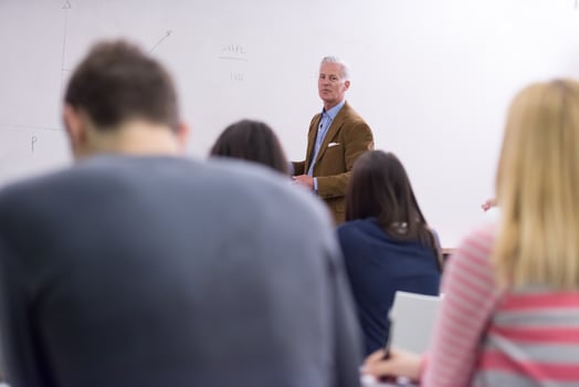 teacher with a group of students in classroom photo