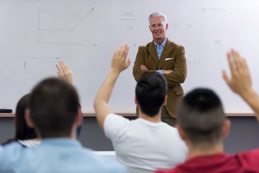 teacher with a group of students in classroom photo