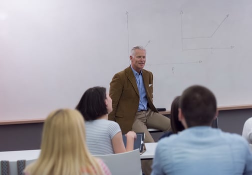 teacher with a group of students in classroom photo