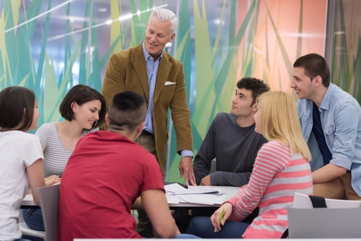 teacher with a group of students in classroom photo
