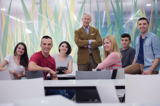 portrait of  teacher with students group in background photo