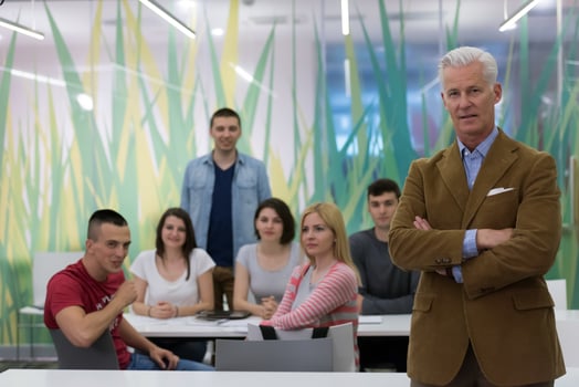portrait of  teacher with students group in background photo