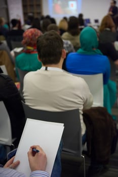 taking notes on business conference photo