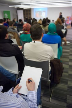 taking notes on business conference photo
