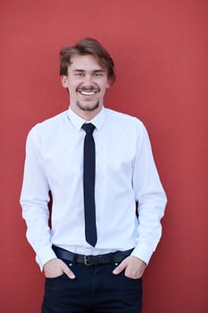 portrait of startup businessman in front of pink wall photo
