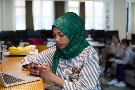 african muslim business woman using mobile phone photo