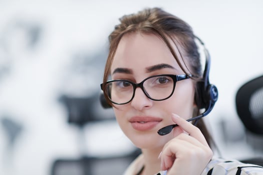 Business woman with headsets at work photo