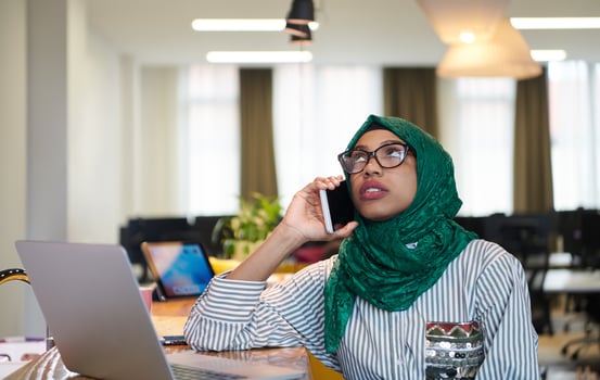 african muslim business woman using mobile phone photo