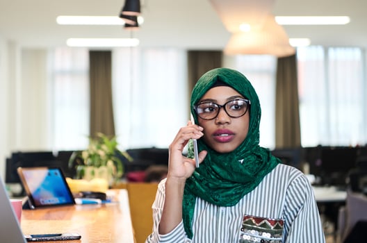 african muslim business woman using mobile phone photo
