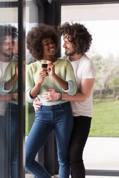 happy multiethnic couple relaxing at modern home indoors photo