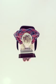 top view of young business woman working on laptop computer photo