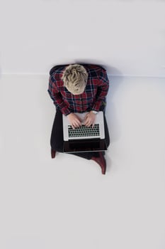 top view of young business woman working on laptop computer photo