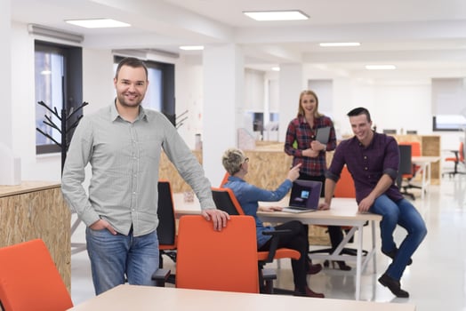 startup business, businessman portrait at modern office, team brainstorming in background photo