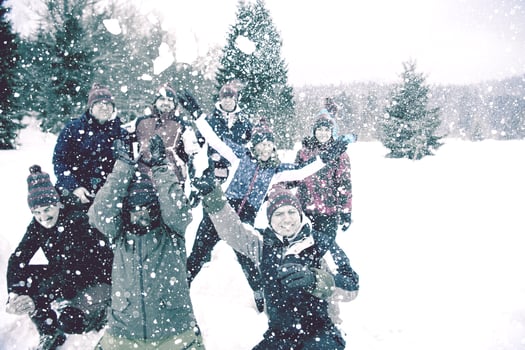 group of young people throwing snow in the air photo