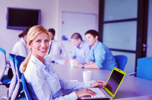 business woman with her staff in background at office photo
