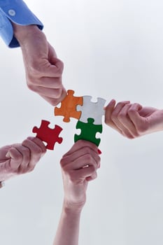 Group of business people assembling jigsaw puzzle photo