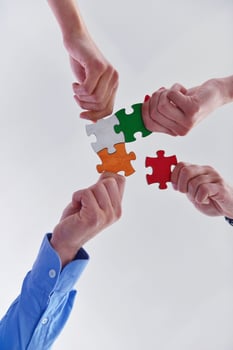 Group of business people assembling jigsaw puzzle photo