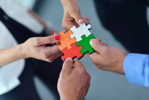 Group of business people assembling jigsaw puzzle photo
