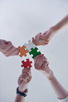 Group of business people assembling jigsaw puzzle photo