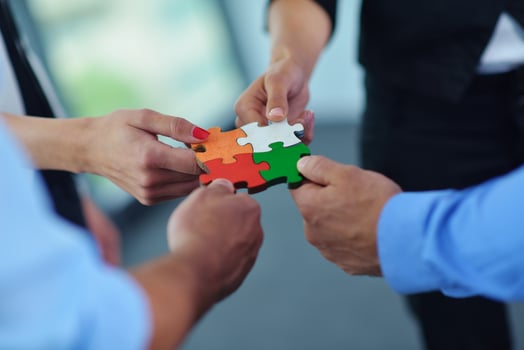 Group of business people assembling jigsaw puzzle photo